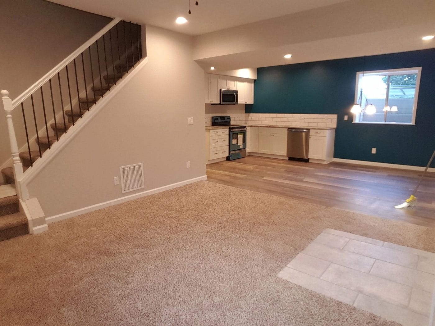 A finished lower level with a stair and a wet bar